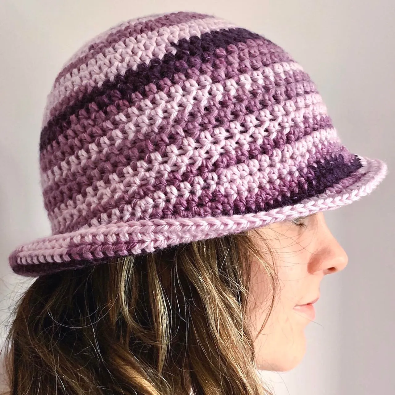 Handmade striped crochet bucket hat in purple shades