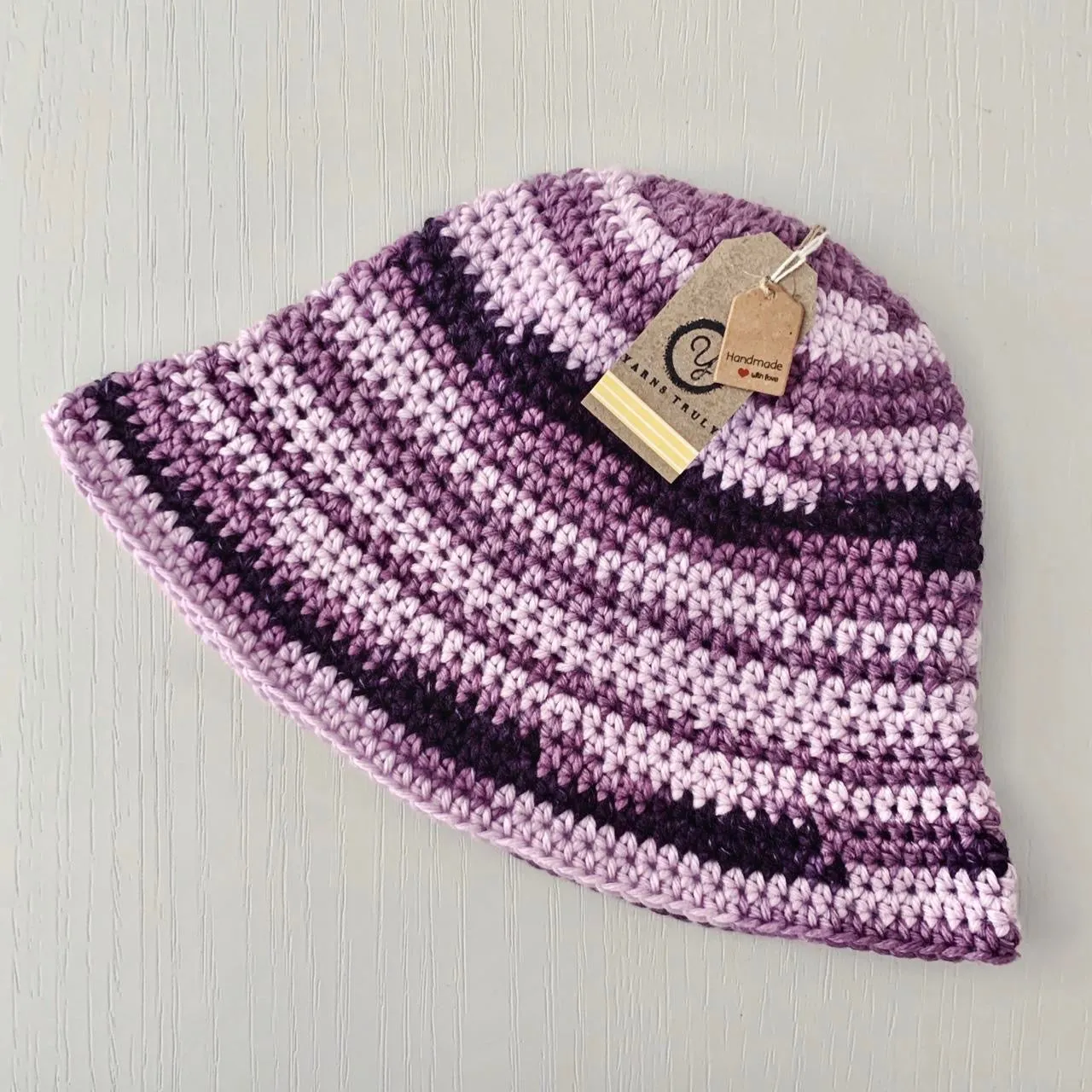 Handmade striped crochet bucket hat in purple shades